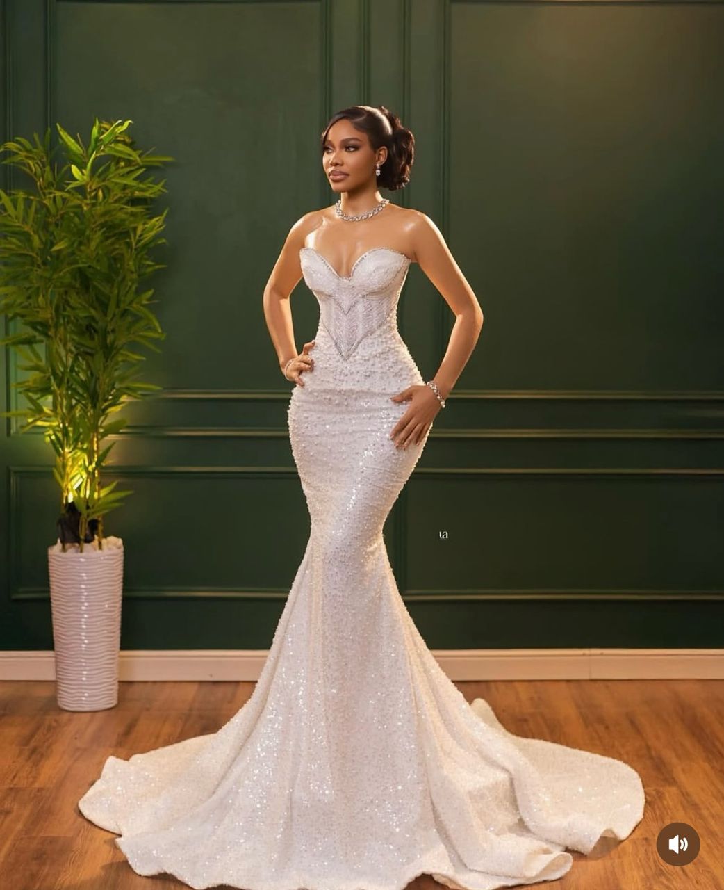 Bride in pearl-embellished mermaid gown with diamond necklace