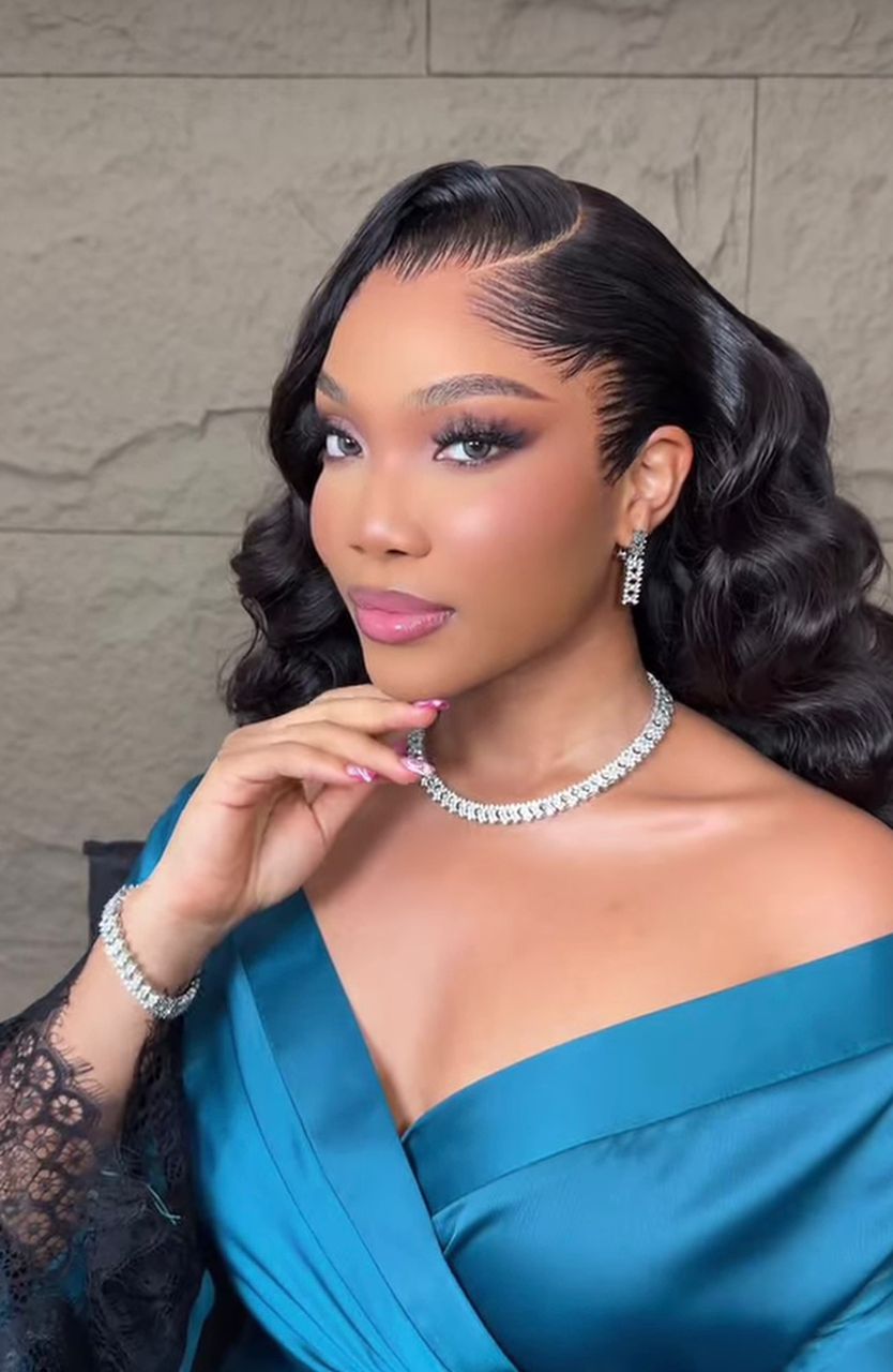 Model in teal satin gown with diamond choker and bracelet